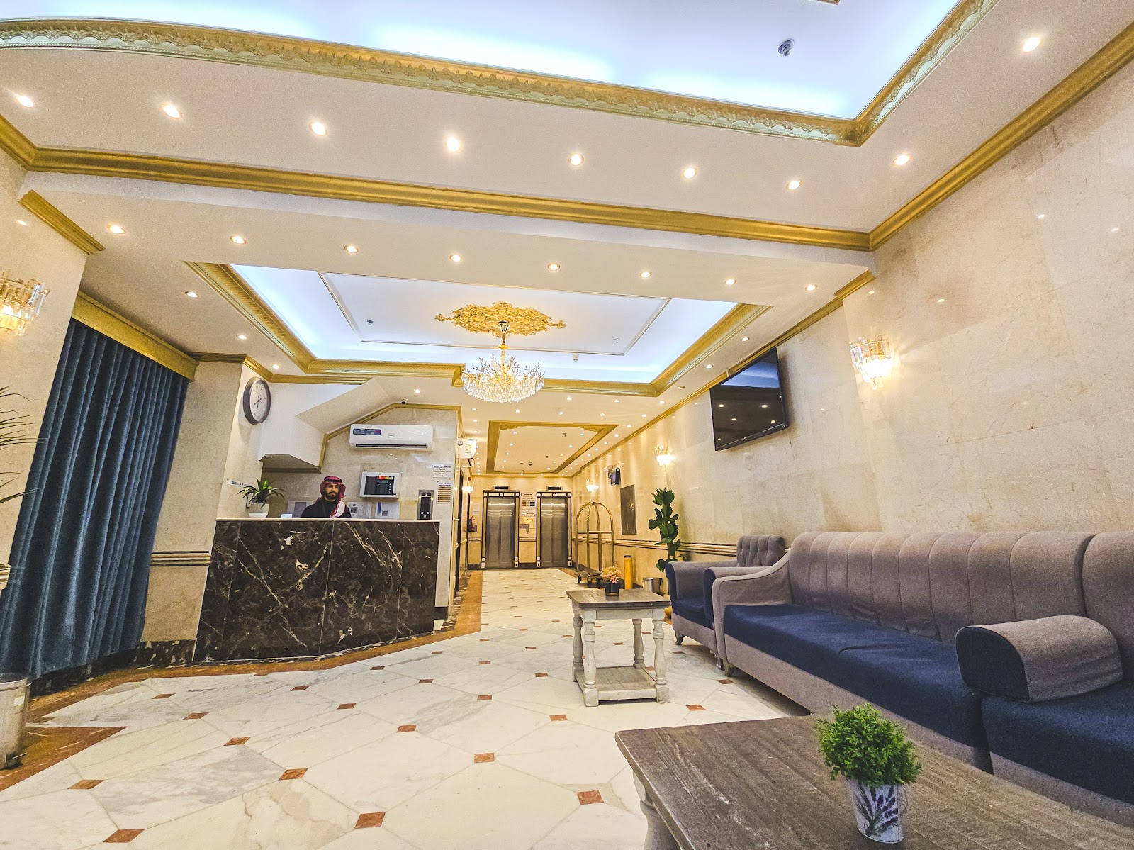 The elegant hotel lobby and reception area, featuring sophisticated decor, comfortable seating, and access to elevators, creating a welcoming first impression.
