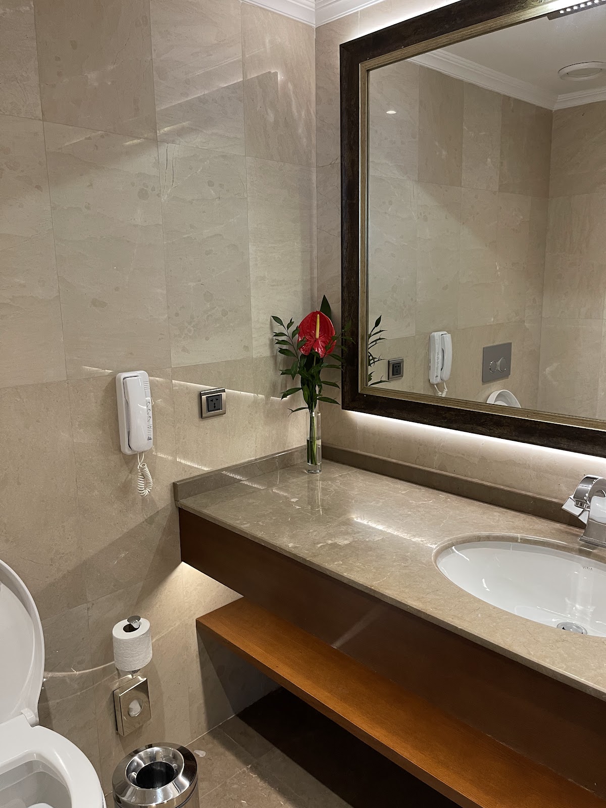 A grand ballroom or event space set up with multiple round tables for a banquet or conference, featuring elegant lighting and carpeting.