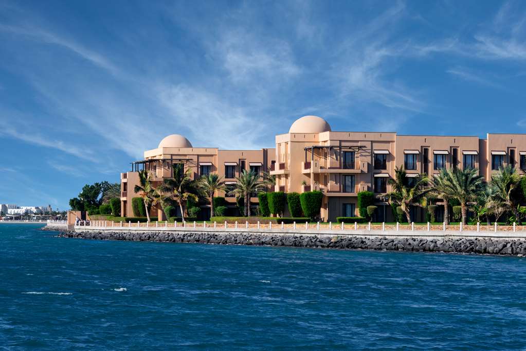 The waterfront exterior of Park Hyatt Jeddah, showcasing its distinctive traditional architecture with domed structures, balconies, and lush landscaping along the Red Sea.