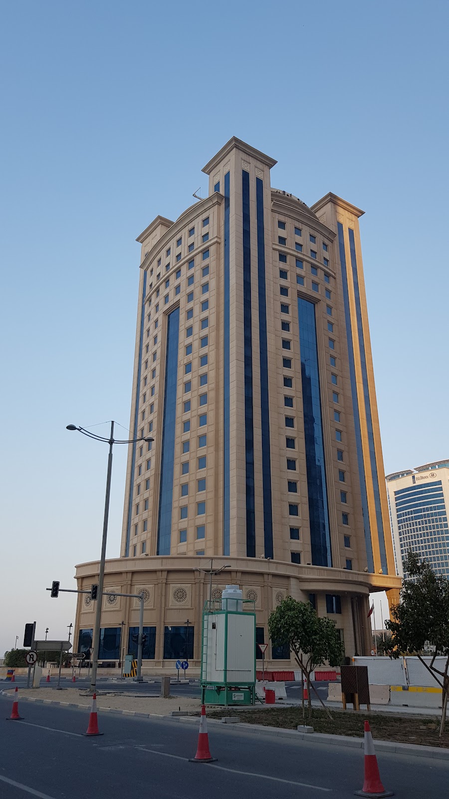 Another street-level perspective of the Retaj Al Rayyan Hotel building, highlighting its architectural details under natural light.