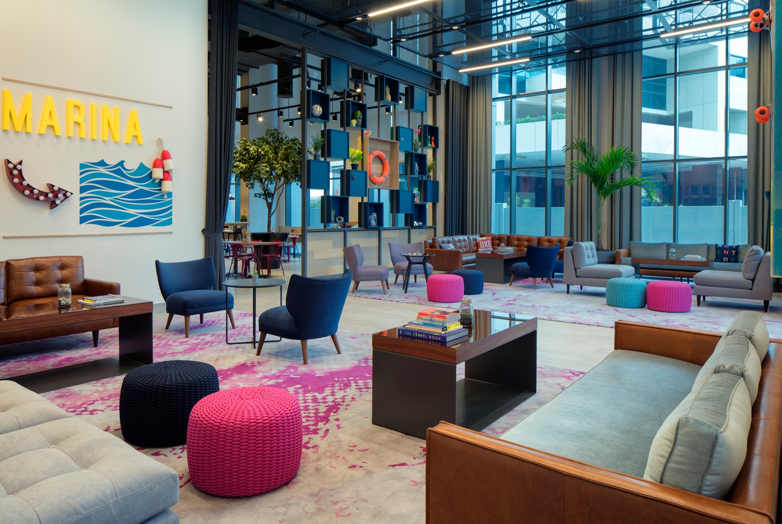 Stylish and spacious lobby lounge area at Rove Dubai Marina, with eclectic seating arrangements.