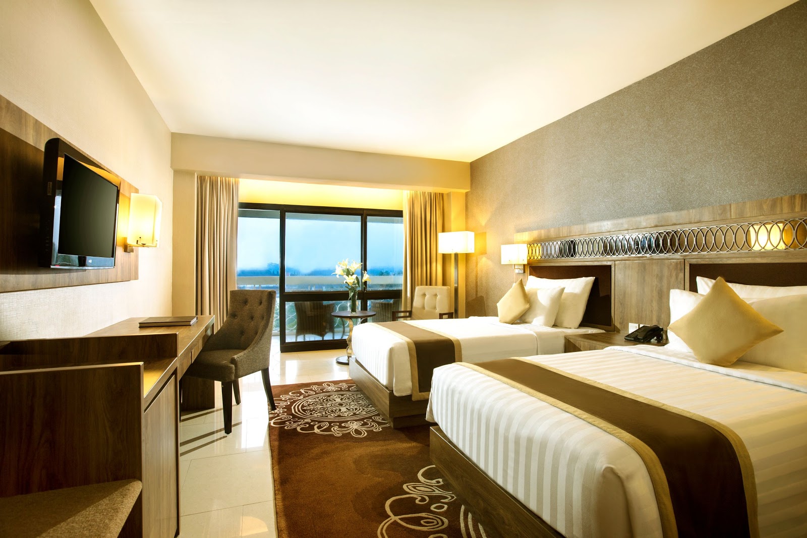 A bright and elegantly appointed guest room featuring two comfortable double beds and a private balcony.